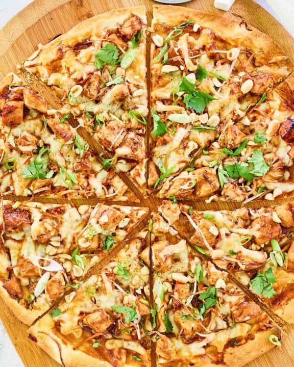 Overhead view of copycat California Pizza Kitchen Thai chicken pizza on a pizza peel.