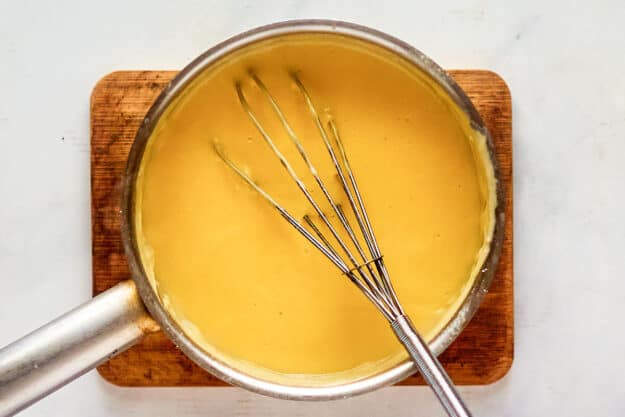 Turkey devonshire cheese sauce in a saucepan.