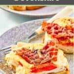 Open-faced turkey devonshire sandwich on a grey plate.