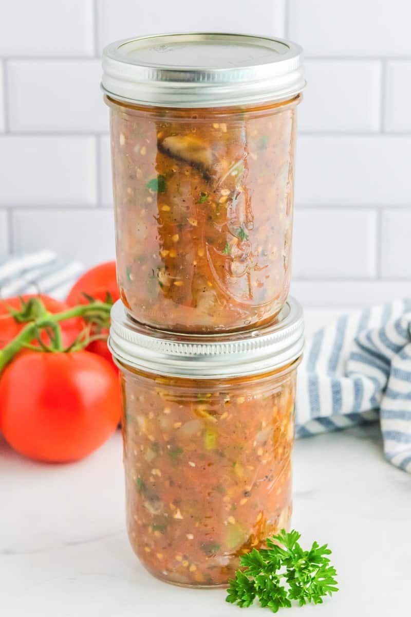 Stack of jars of homemade canned spaghetti sauce.