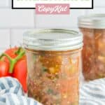 Canned spaghetti sauce in a mason jar on top of a kitchen towel.