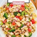 Overhead view of chicken pasta salad on a white platter.