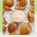 Copycat Chili's awesome blossom petals and dipping sauce on parchment paper.