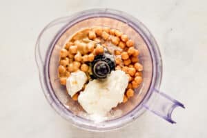 Creamy hummus ingredients in a food processor.