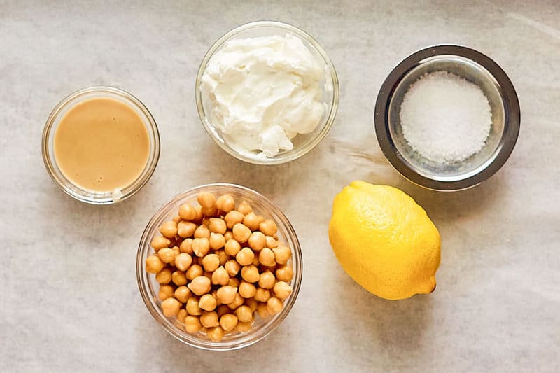 Creamy hummus ingredients on parchment paper.