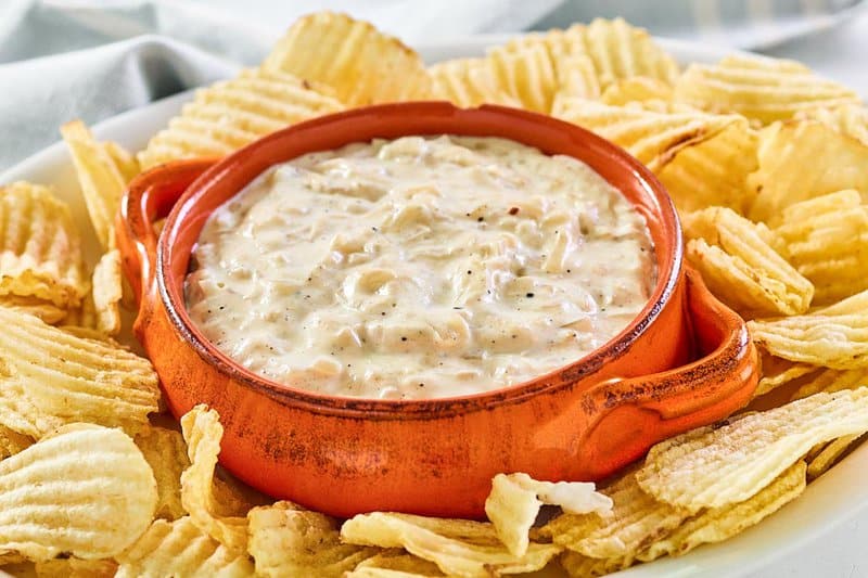Ina Garten onion dip and potato chips on a platter.