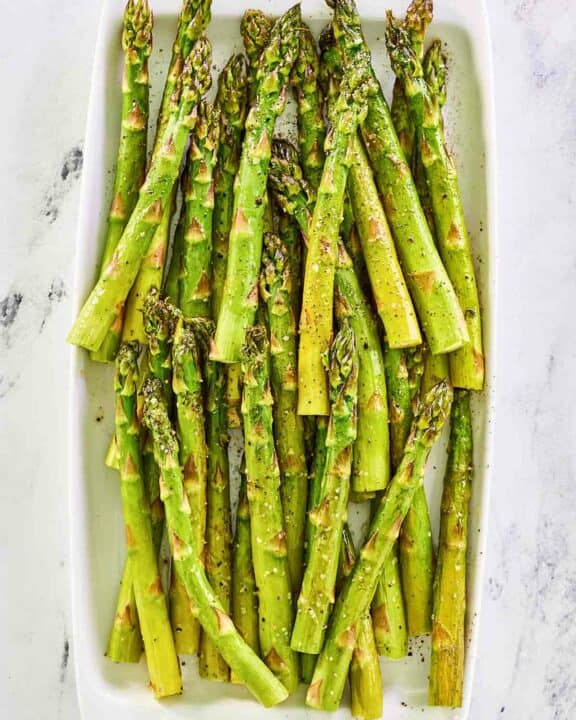 Overhead view of oven roasted asparagus on a platter.