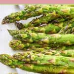Roasted fresh asparagus on a white platter.