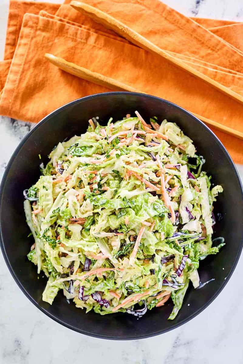 Overhead view of sweet and sour coleslaw in a bowl.