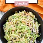 Overhead view of sweet and sour coleslaw in a black bowl.
