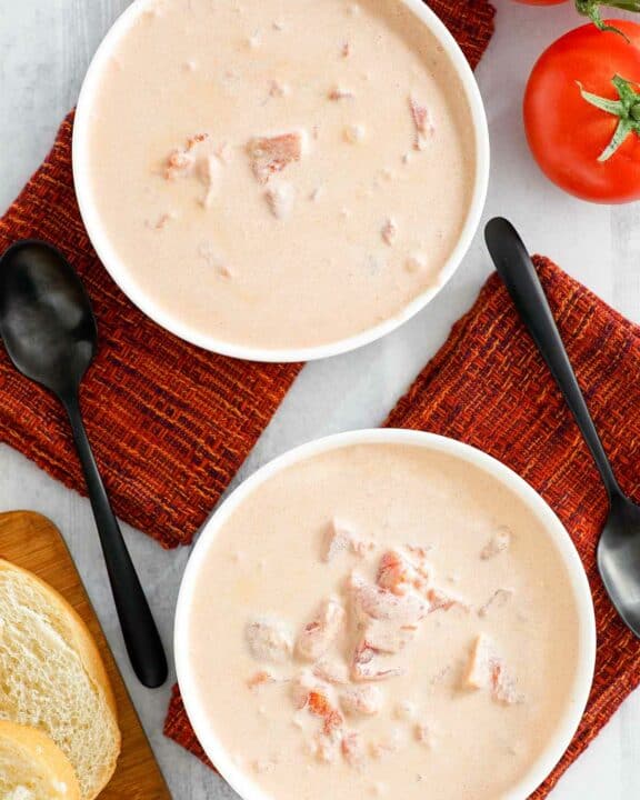 Overhead view of copycat 4B's creamy tomato soup in two bowls.
