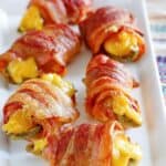 Air fryer bacon wrapped jalapeno poppers on a platter.