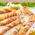 Bacon wrapped cheese stuffed hatch peppers on white parchment paper.