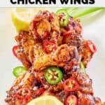 Homemade Buffalo Wild Wings Asian Zing chicken wings and lemons on a plate.