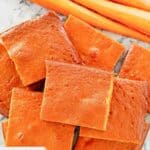 Overhead view of carrot pudding slices and fresh carrots.