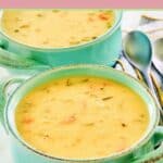 Cheddar cheese soup in two soup crocks.