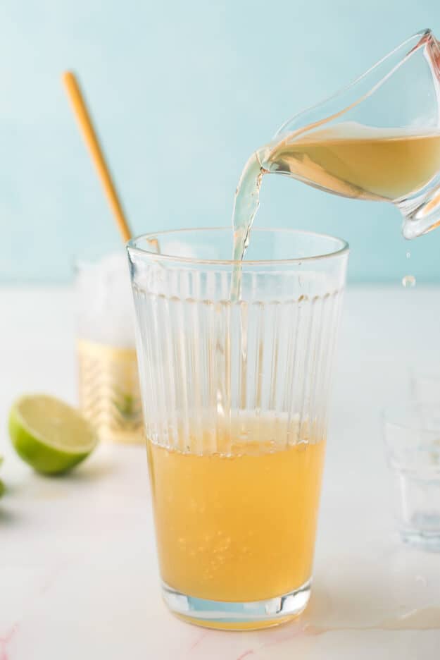 Pouring tequila into a glass to make Chili's Presidente margarita.