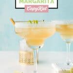 Homemade Chili's Presidente Margarita on a coaster and lime wedges by it.