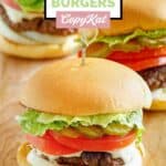 Three homemade Culver's butter burgers on a wood serving board.
