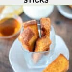 Homemade Burger King French toast sticks on a plate and a bowl of syrup.