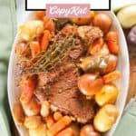 Overhead view of instant pot tri tip roast and veggies on a white platter.