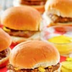 Several homemade Krystal burgers on red checkered parchment paper.