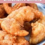 Closeup of homemade Long John Silvers chicken planks on a blue plate.