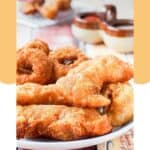Homemade Long John Silver's chicken planks and onion rings on a plate.