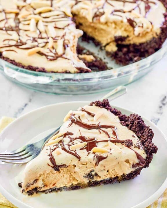 Ice cream mud pie with Oreo crust in a pie dish and a slice on a plate.
