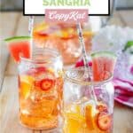 Homemade Olive Garden watermelon sangria in glasses and garnished with watermelon.