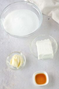 Overnight cinnamon rolls cream cheese frosting ingredients in bowls.