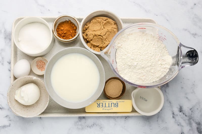 Overnight cinnamon rolls ingredients on a tray.