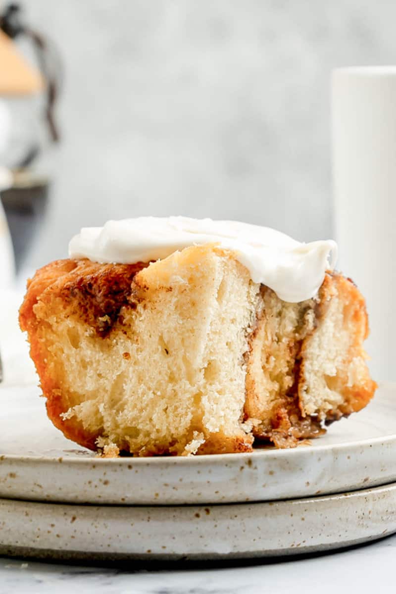Closeup of a cinnamon roll with cream cheese frosting.