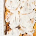 Closeup overhead view of overnight cinnamon rolls with frosting.