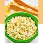 A bowl of pineapple coleslaw and salad tongs.