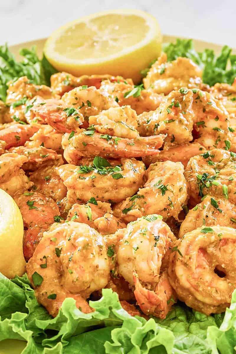 Shrimp remoulade on top of lettuce on a platter.