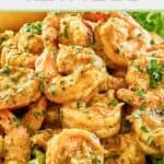 Shrimp remoulade on top of lettuce leaves.