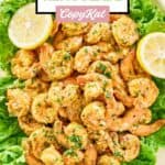 Overhead view of shrimp remoulade and lemons over lettuce on a platter.