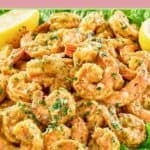 Shrimp remoulade, lettuce, and lemons on a platter.