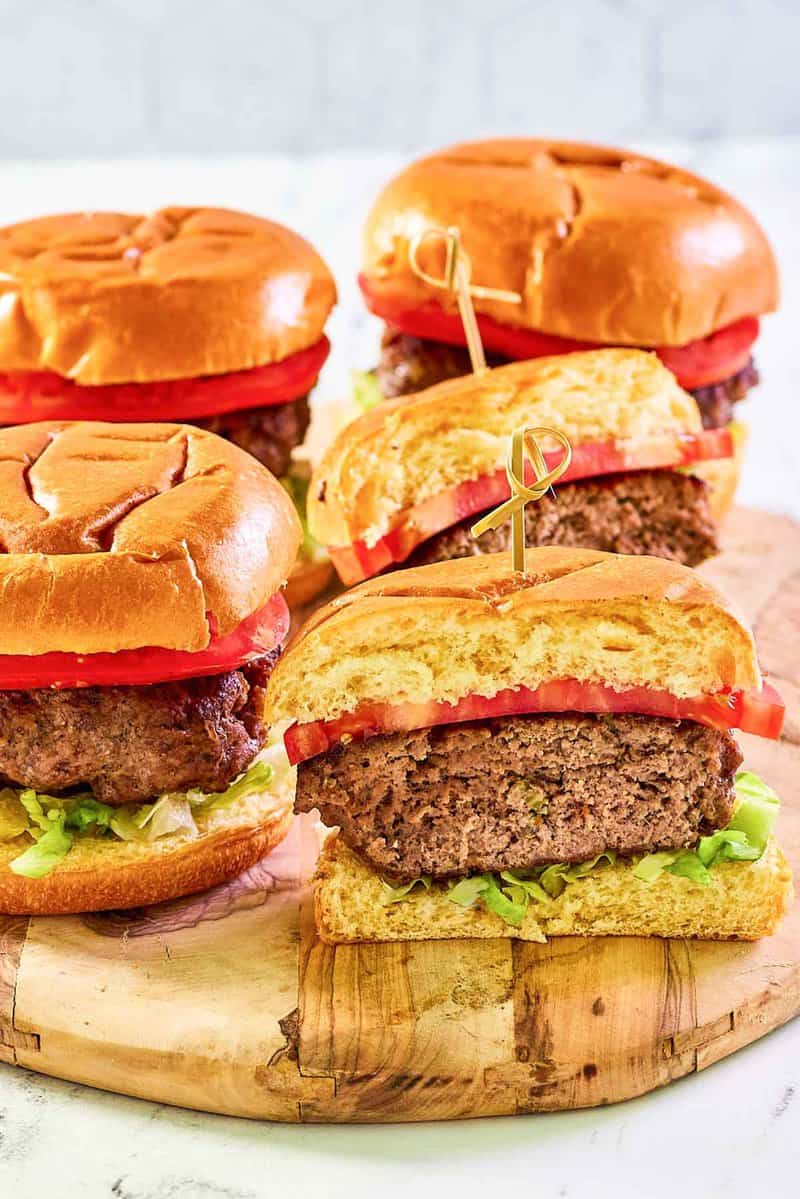 Copycat 21 Club burgers on a serving board.