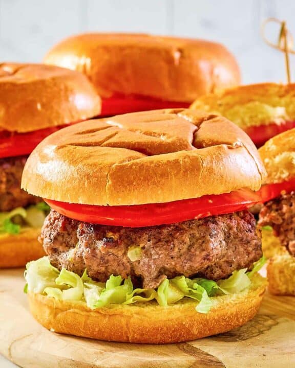 Copycat 21 Club burger on a wood board.