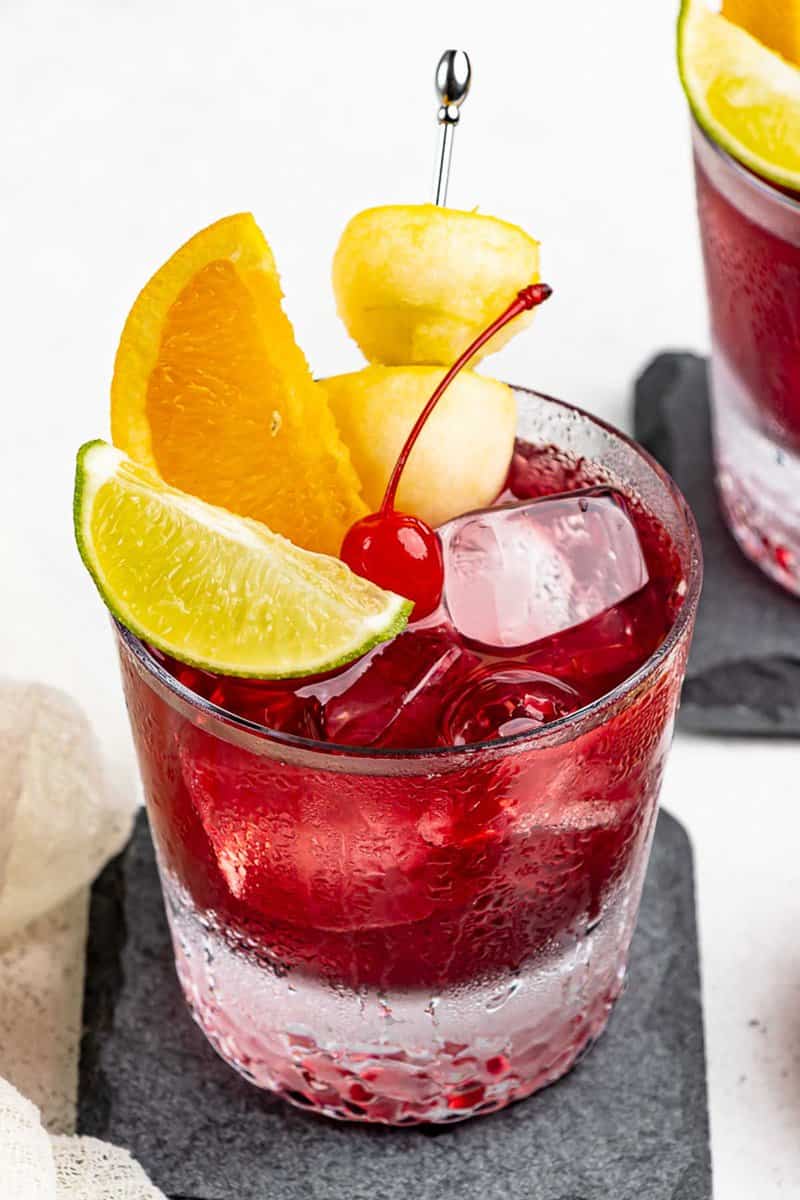 Copycat Applebee's red apple sangria garnished with apple and other fruit.
