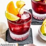 Homemade Applebee's red apple sangria and a bowl of maraschino cherries.