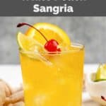 Homemade Applebee's white peach sangria in a glass on a coaster.