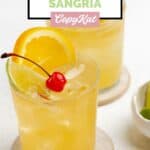 Homemade Applebee's white peach sangria in a lowball glass.