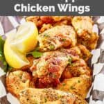 Homemade Buffalo Wild Wings lemon pepper chicken wings and lemon wedges.