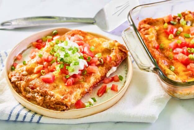 Burrito casserole serving on a plate and the casserole in a glass baking dish.