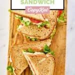 Overhead view of copycat Chick Fil A chicken salad sandwiches on a wood board.