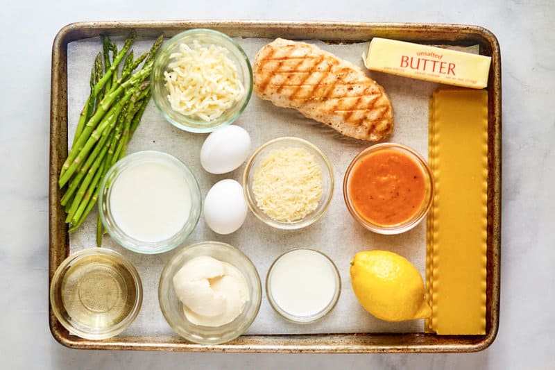 Chicken lasagna ingredients on a tray.