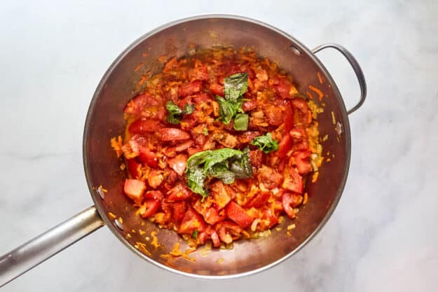 Cooking marinara sauce in a skillet.